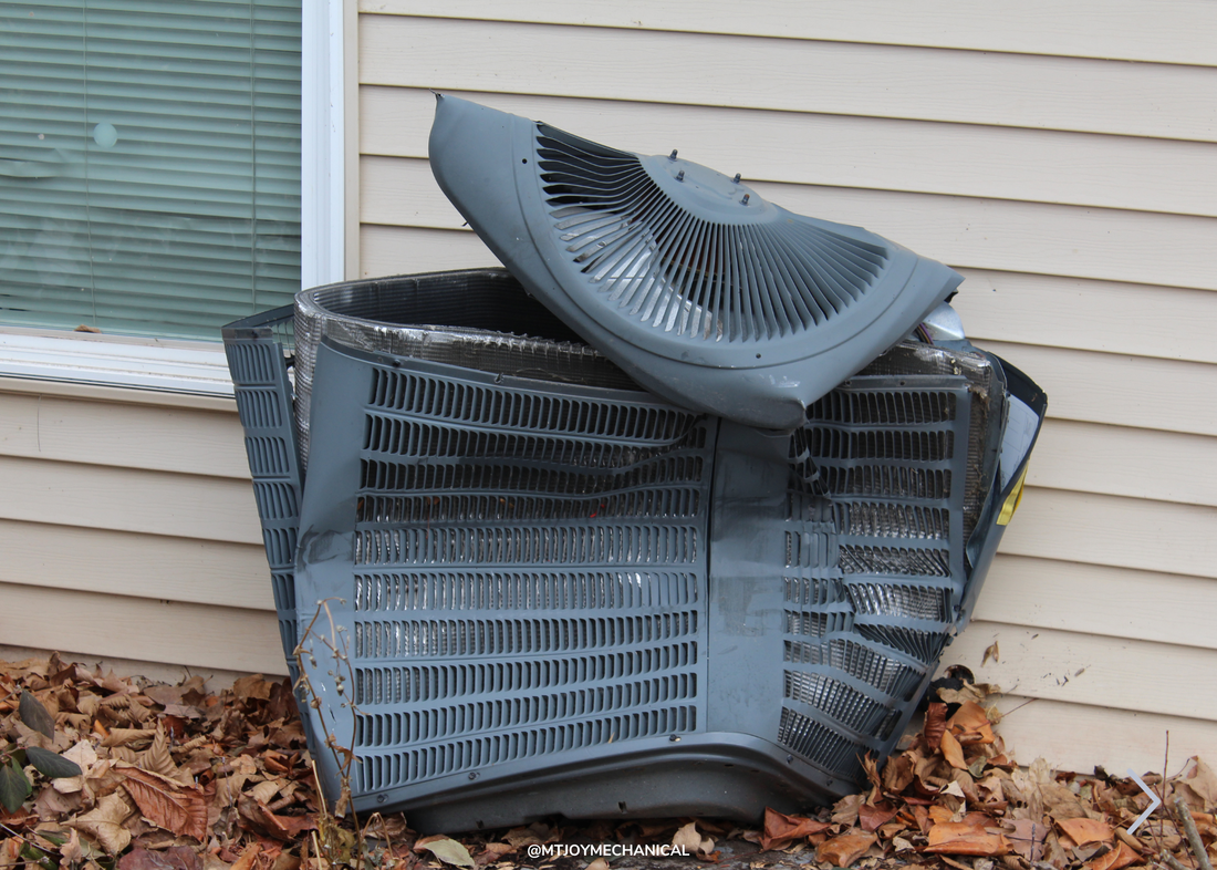 Demolished HVAC unit on exterior of home